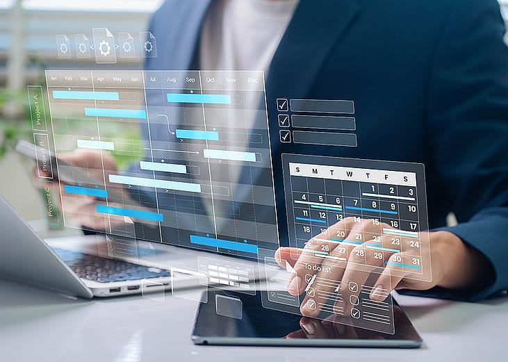Businessman navigating calendars and project management tools
