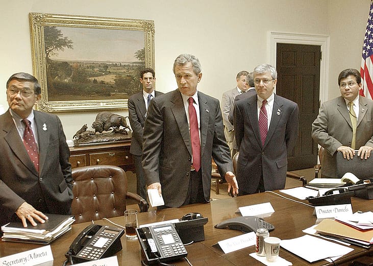 Former US President George W. Bush (2L) meeting with Transportation Secy. Norman Mineta (L), Deputy Chief of Staff Josh Bolten (2R) & WH Counsel Al Gonzalez.