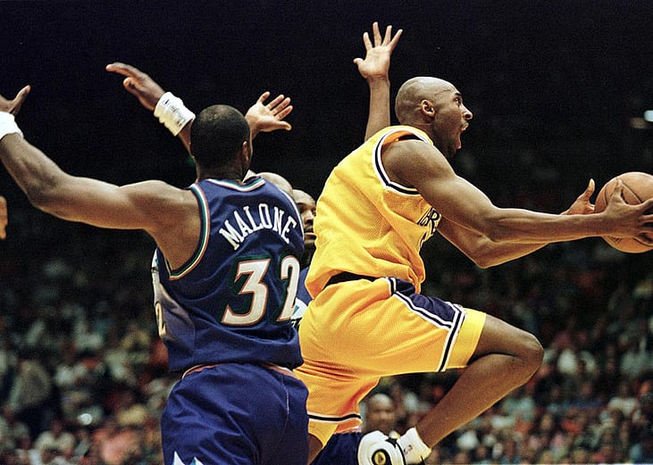 LA Lakers player Kobe Bryant (R) jumps to score during the third game of the NBA playoffs against Utah Jazz in Inglewood, California.
