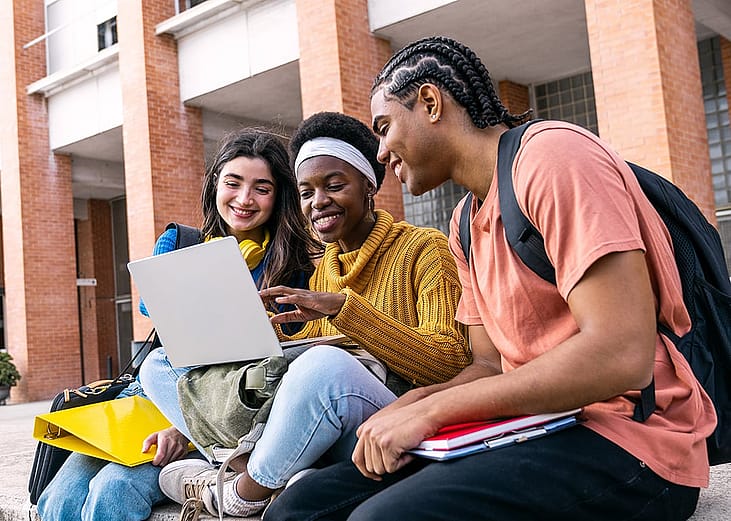 A group of college students collaborating outdoors.