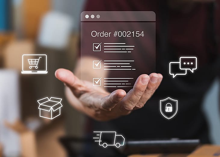 A worker checking digital order checklists surrounded by shipping packages.