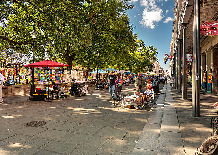 Outdoor market stalls along New Orleans French Quarter.