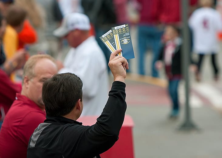 An unidentified person trying to sell tickets to the SEC Championship game outside the Georgia Dome in Atlanta, Georgia, USA.