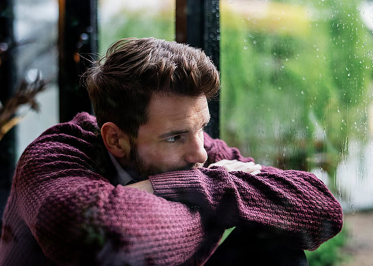 A thoughtful man looking out the window
