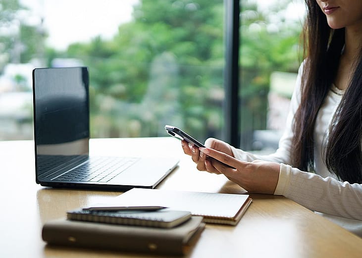 A young woman working remotely in a cafe