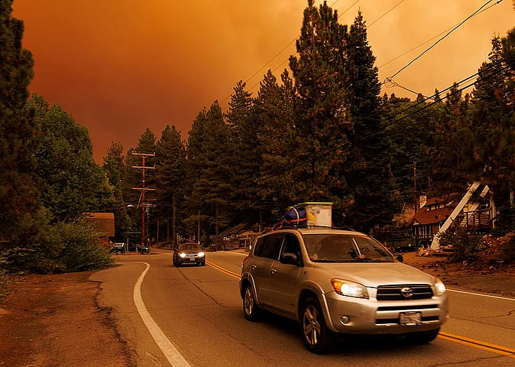 Cars driving away from the Line wildfire in Green Valley Lake, California, USA in September 2024.