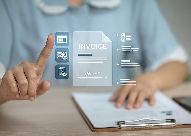 An finance professional utilizing a digital invoice controller for calculation of accounts payable and related payments. 