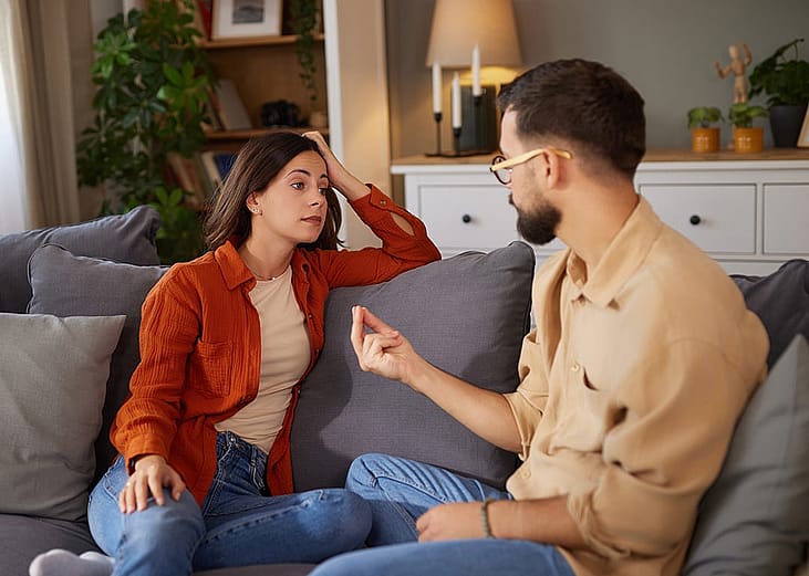 A couple at home having a serious conversation.