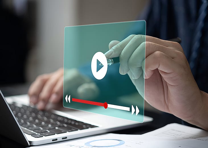 A person streaming a video online through a laptop. 