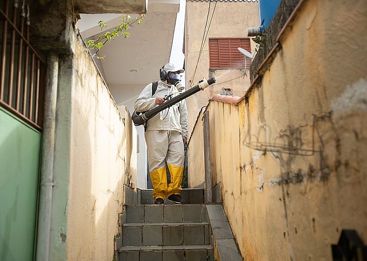 A city worker fumigates a neighborhood to fight against the Egyptian tiger mosquito.