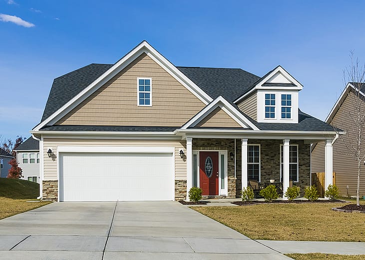 View of a modern suburban single-family house with a two-car garage.