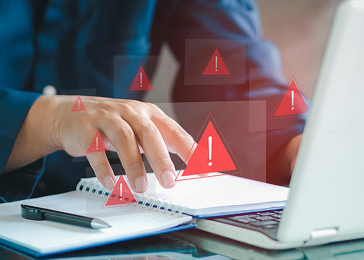 An employee receiving security alerts from a fraud attack on his laptop's network.