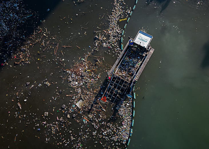 Aerial view of an interceptor by The Ocean Cleanup collecting trash from the ocean.