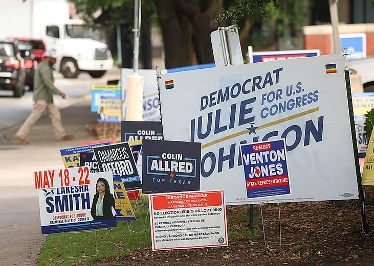 Signs are displayed outside of a voting center during primary election runoff day at Oak Lawn Library on Tuesday, May 26, 2026 in Dallas.