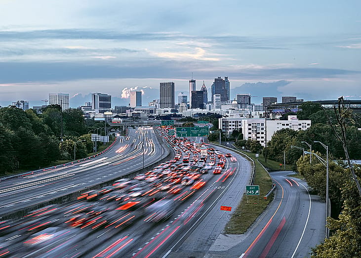 Skyline showing several prominent buildings, highways, and cars.
