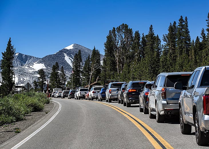 A line of cars creeps slowly to the Tioga Pass Highway 120 entrance of Yosemite National Park.