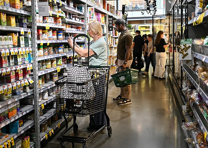 People shopping for grocery items at a Manhattan supermarket in New York City, USA.