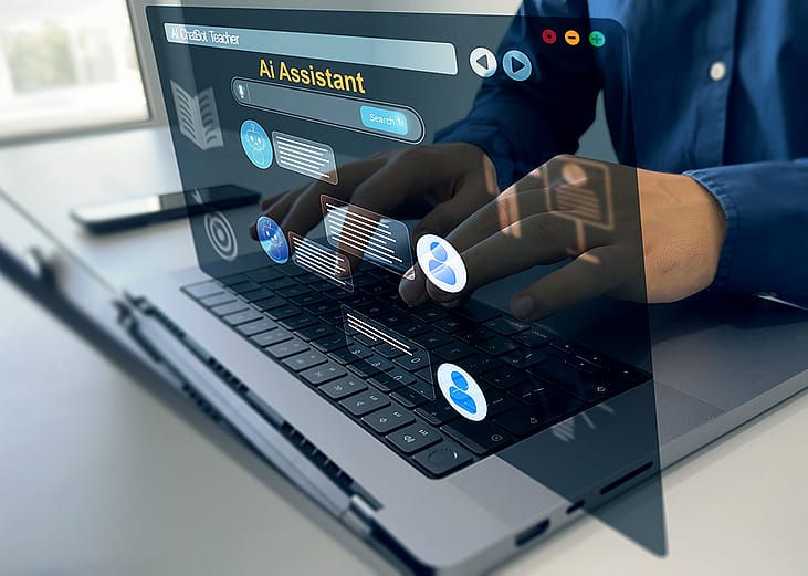 A conceptual graphic of a person using an AI chatbot on a laptop.
