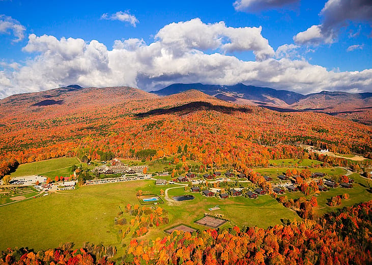 An aerial view of the Trapp Family Lodge with a view of Mount Mansfield in Austria.