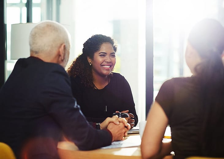 A group of professionals having a positive discussion during a meeting.