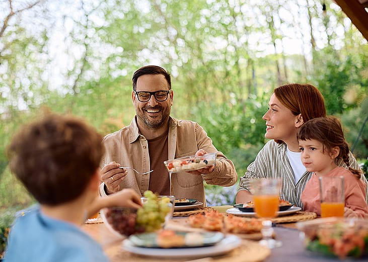A family enjoying their lunch in a restaurant's patio.