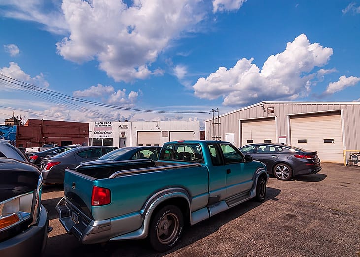 Cars parked outside a car repair garage during daytime in Swissvale, Pennsylvania, USA.