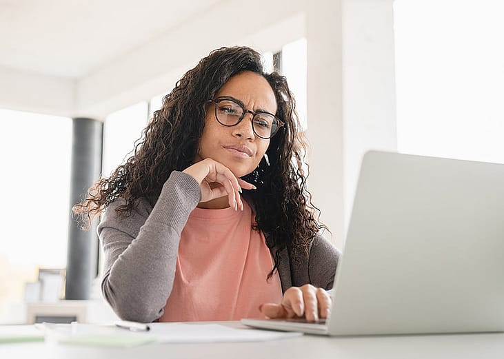 A person reviewing her monthly budget, expenses, and other personal finances from a laptop.