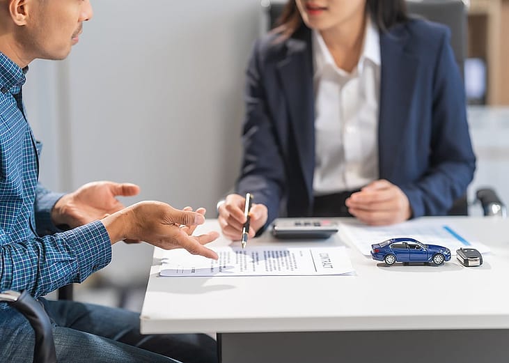 A loan professional guiding a client on a contract.