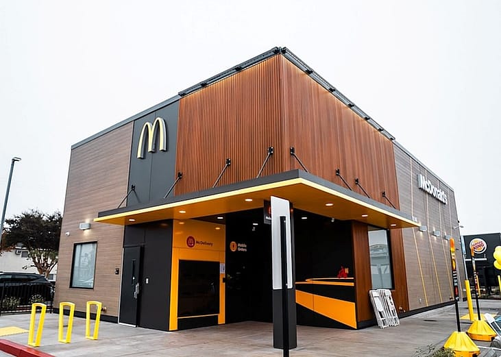 An outside view of a McDonald's "On-The-Go" restaurant tailored for digital and drive-thru orders.