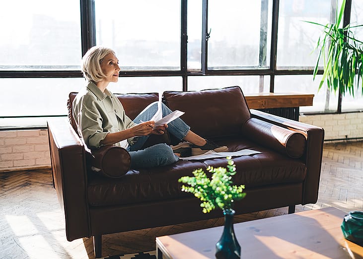 A woman at home reviewing documents.