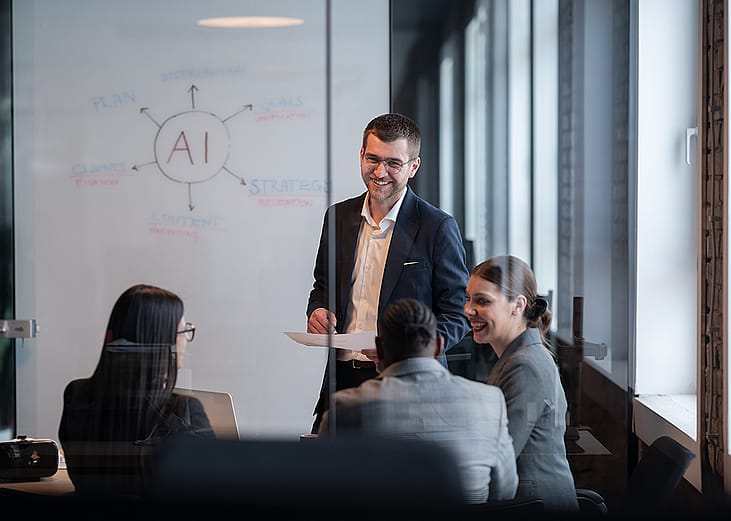 A business team discussing AI in a board room.