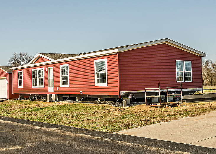 A new manufactured home with bright red exterior.