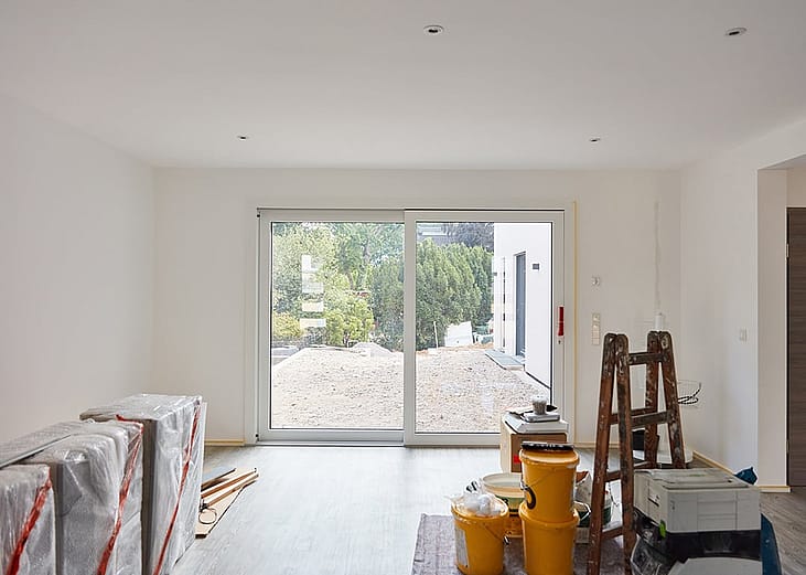 A spacious room overlooking a balcony during a general renovation and finishing.