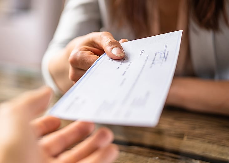 Person cashing in a check for salary.