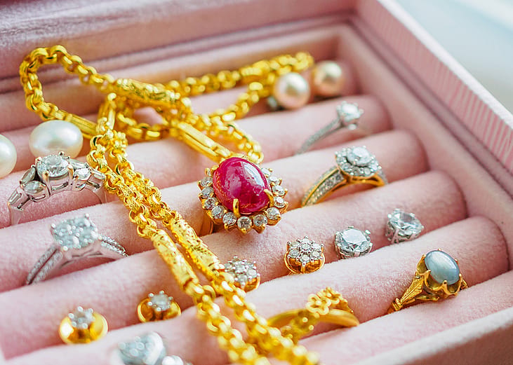 Gold and silver sets of jewelry with gemstones.