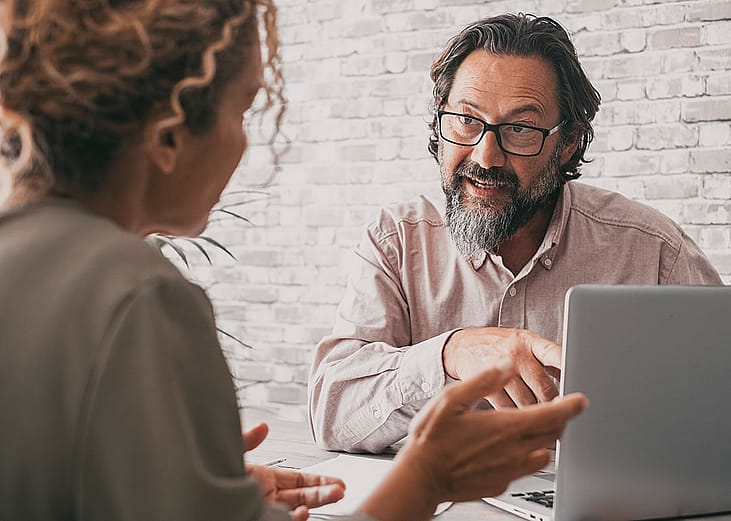 A consultancy professional engaged in discussion with a client.
