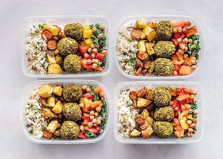 Four plates of a healthy meal prep dish.