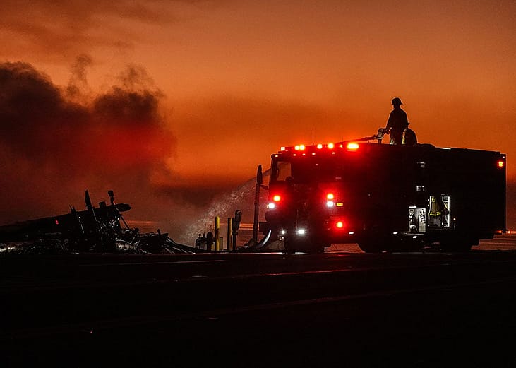Firefighters spray water to combat flames at sunset in Pacific Palisades, California, on January 9, 2025.