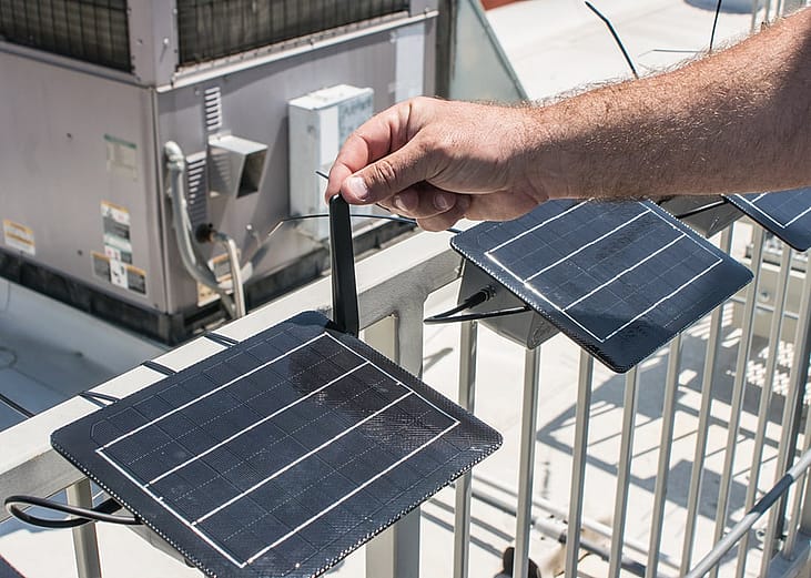 A California official calibrates rooftop air monitoring equipment used to track local air pollution.