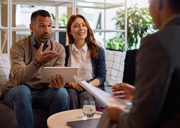 A couple consulting with an insurance professional.