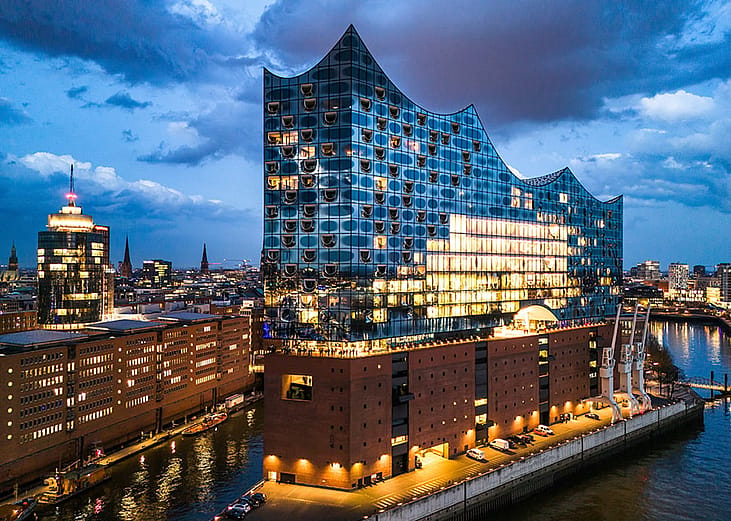 Exterior of Elbphilharmonie Hamburg concert hall at dusk.