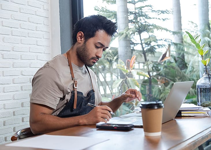 A cafe owner reviewing business documents.