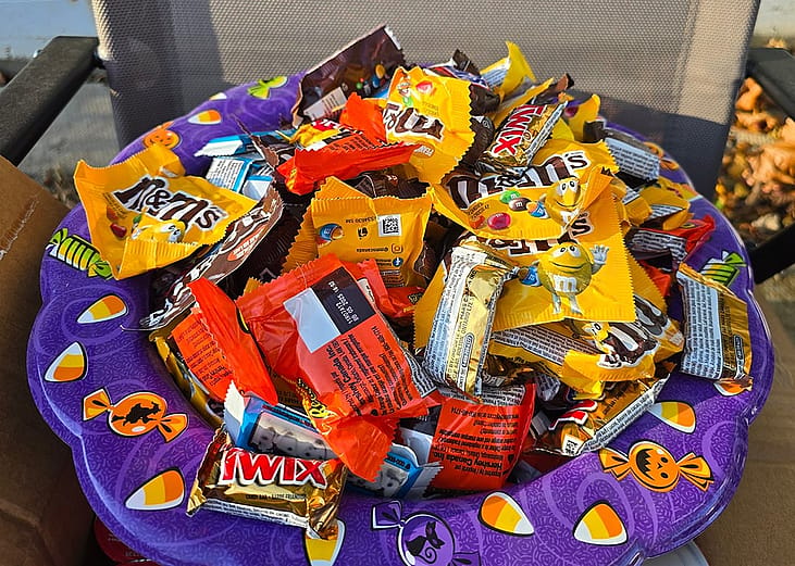 A bowl full of candy for Halloween.