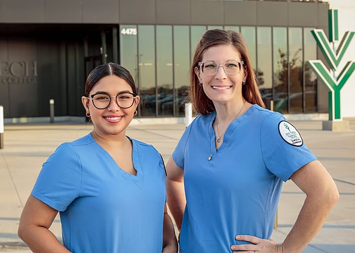 Two surgical technology students stand in front of the Moravec Hall at Ivy Tech Community College in Columbus, Indiana.