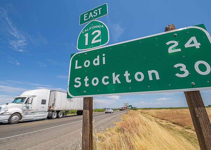 View of signpost and freightliner on Highway 12 in San Francisco, California.