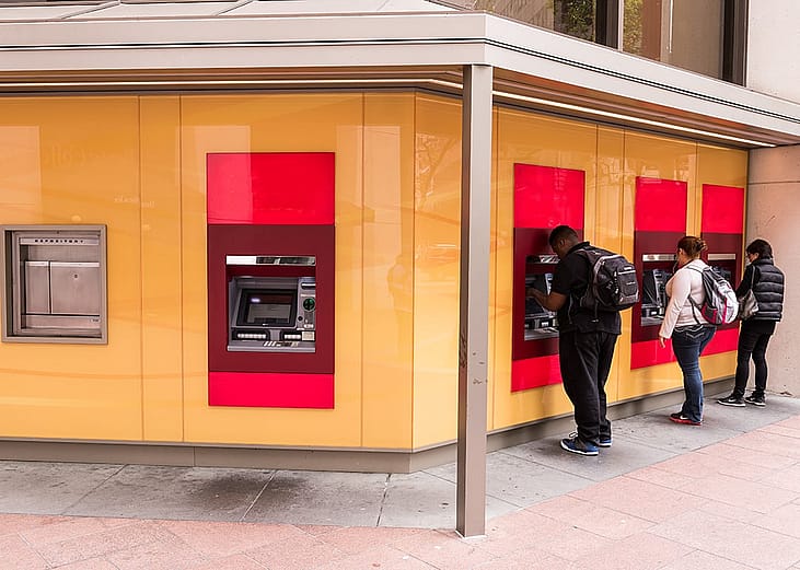 People using ATMs in downtown San Francisco, California, USA.
