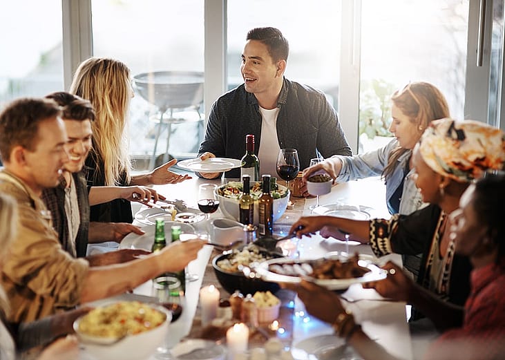 A group of friends sharing a feast together indoors.