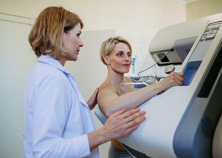 Older woman having yearly mammography for preventive healthcare.