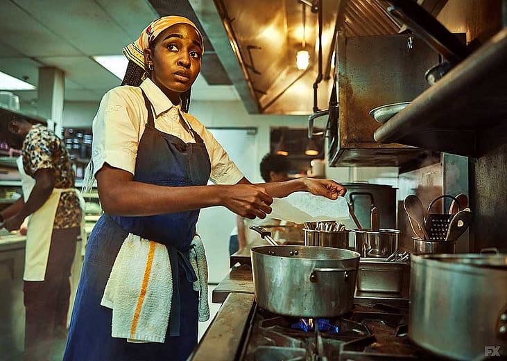 Still image of Ayo Edebiri as Sydney Adamu cooking in season 1 of FX Network's "The Bear".