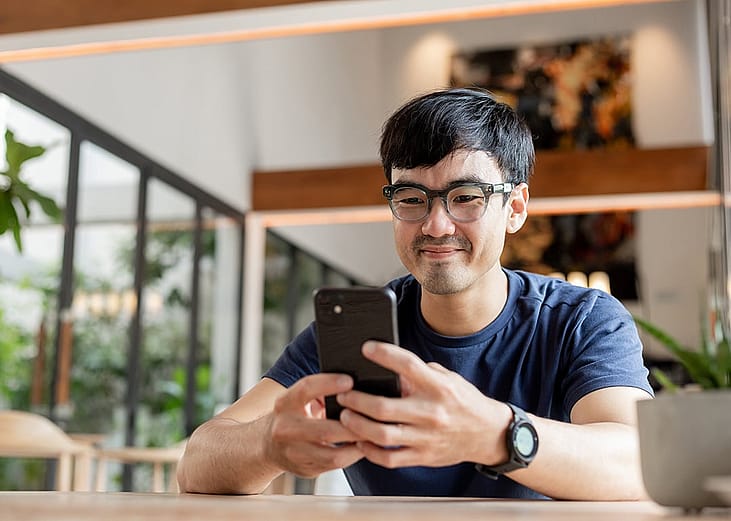 A person asking shopping queries to an AI agent from his smartphone.